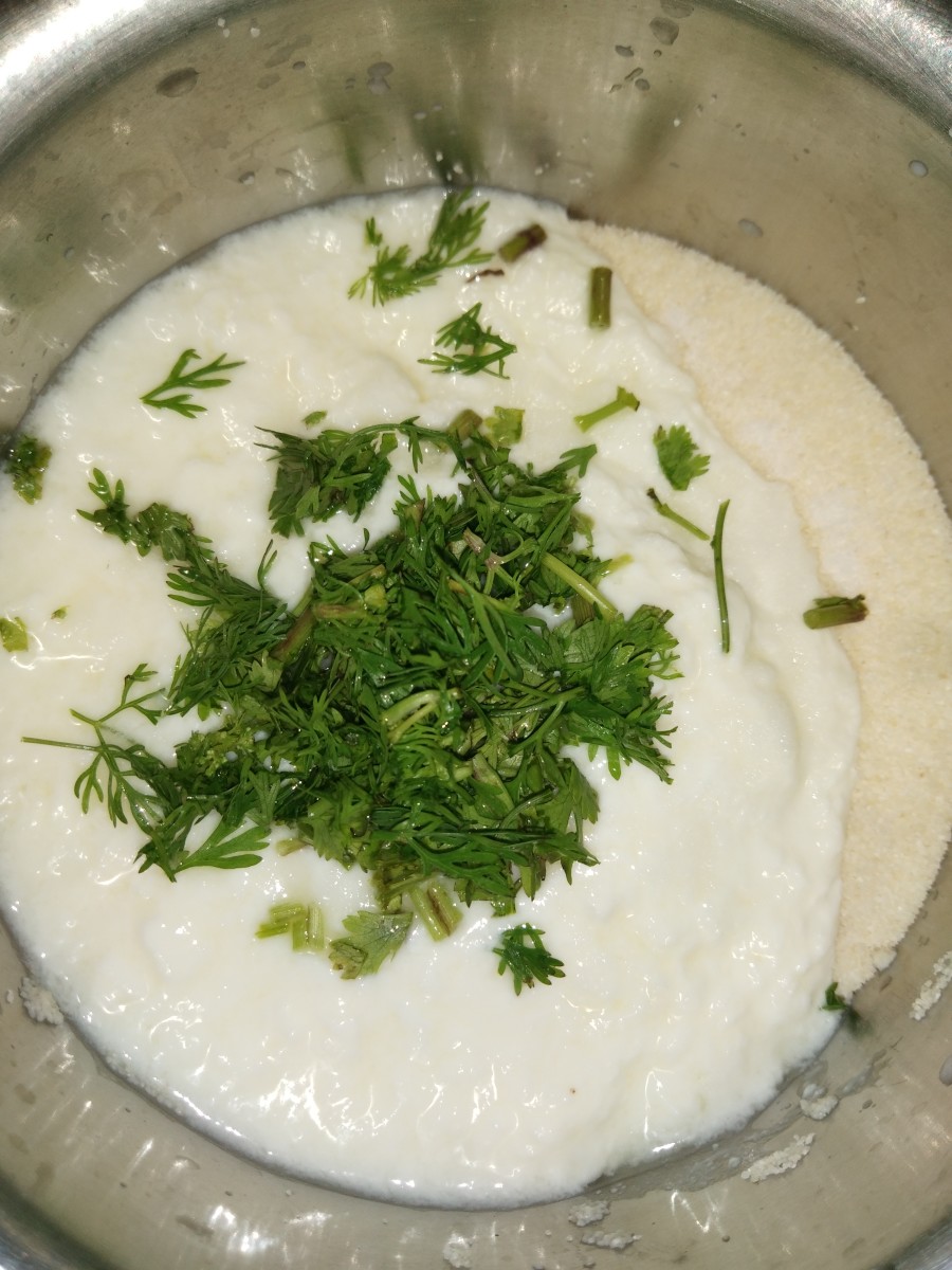 Add curd (yogurt), salt, and finely chopped coriander leaves.