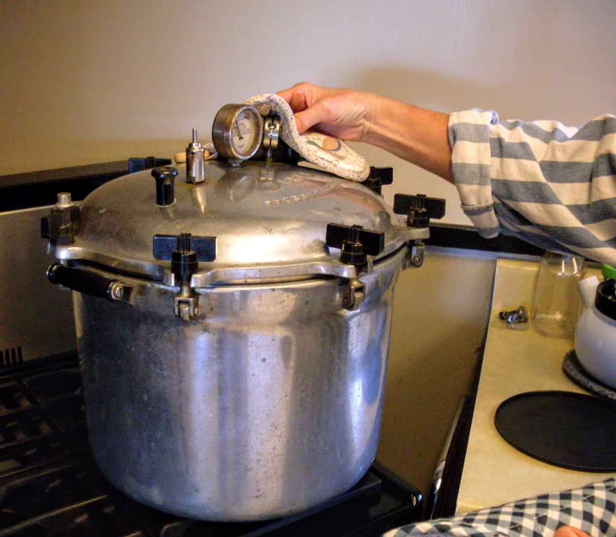 Once the pressure gauge has returned to zero pounds, carefully remove the weight and lid of your canner.
