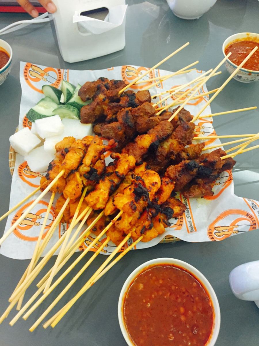 Chicken satay, beef satay, and nasi impit served with the peanut sauce. 