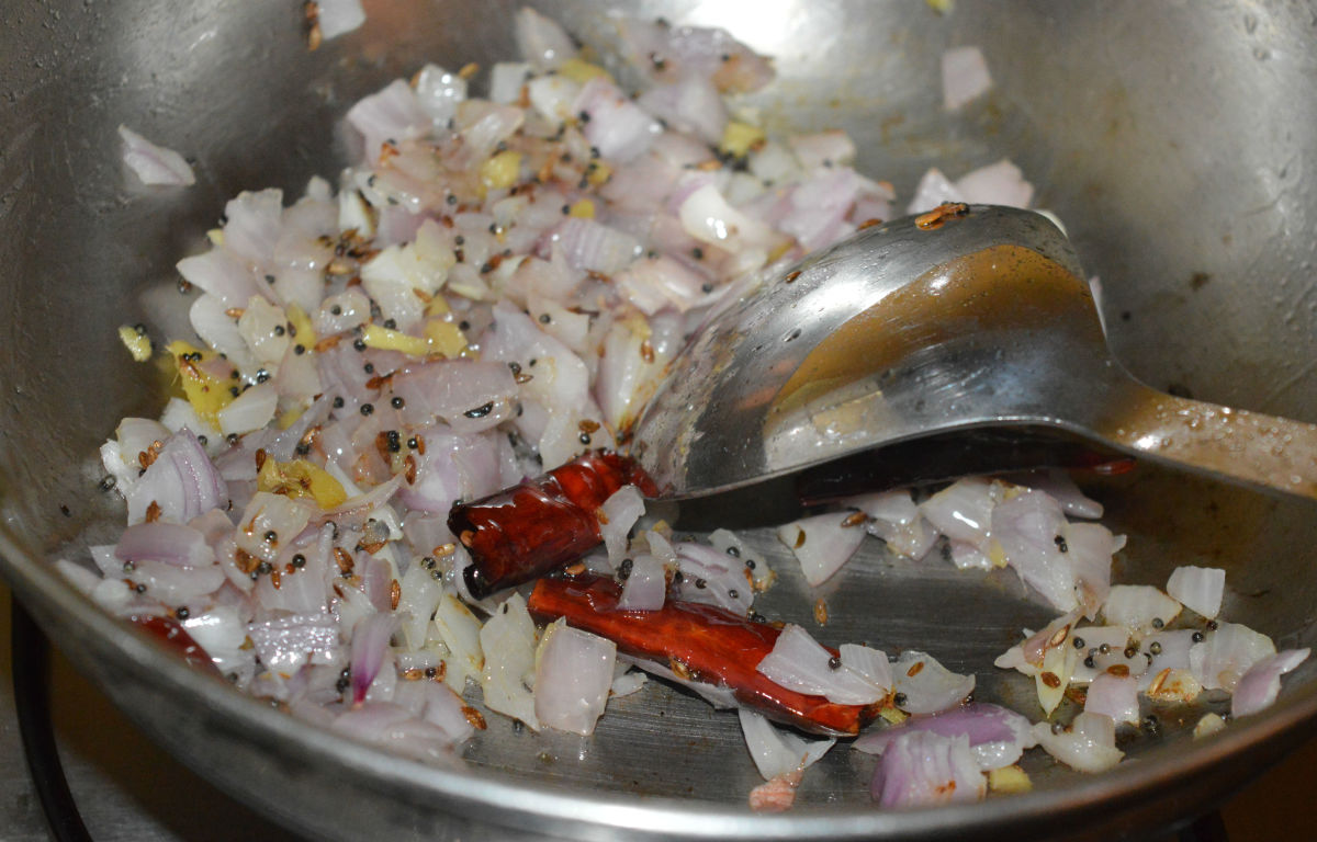 Step two: Add chopped onions and chopped ginger. Saute until onion turn pinkish.