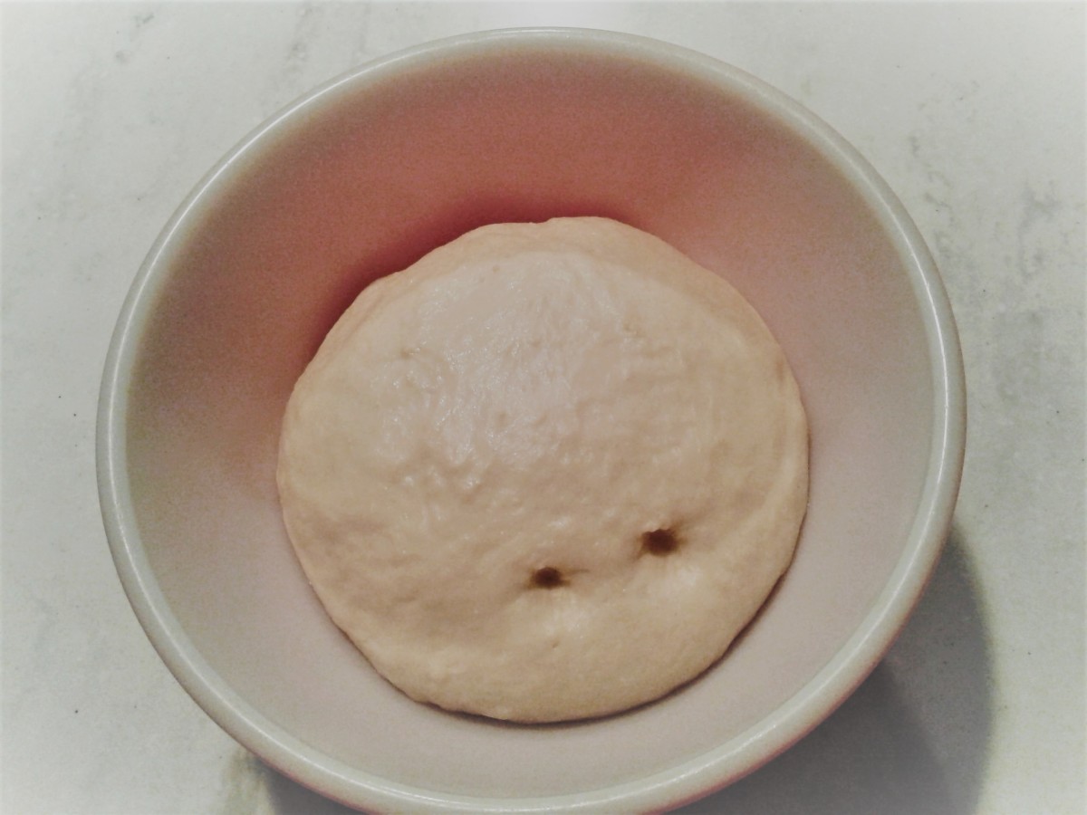 Has the dough risen enough? Gently poke two fingers into the dough. If the indentation remains, the dough is ready. If the indentation fills in quickly, the dough needs to rise a little more.