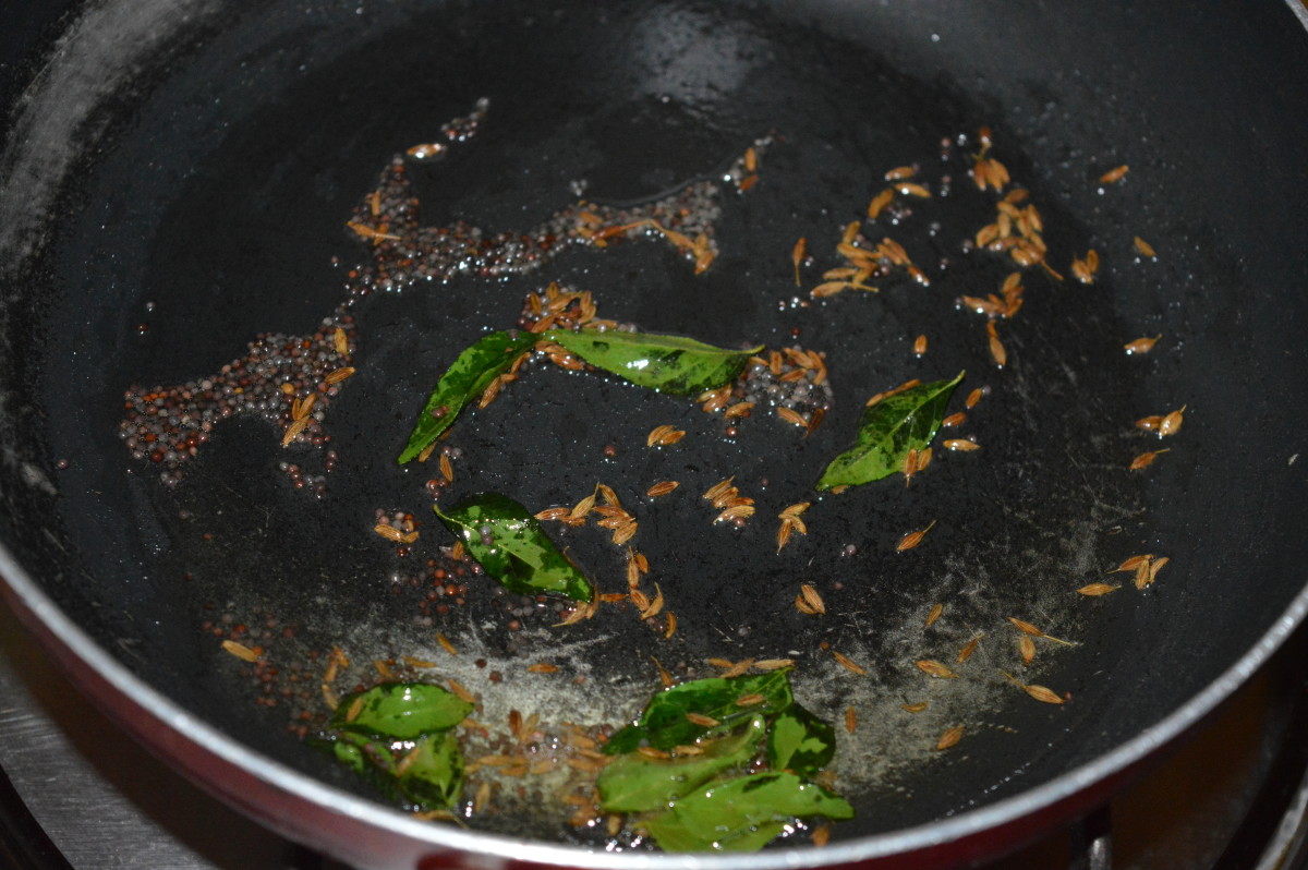 Step two: Heat oil in a deep-bottomed pan. Throw in cumin and mustard seeds. Let them crackle. Add curry leaves and saute for 10 seconds.