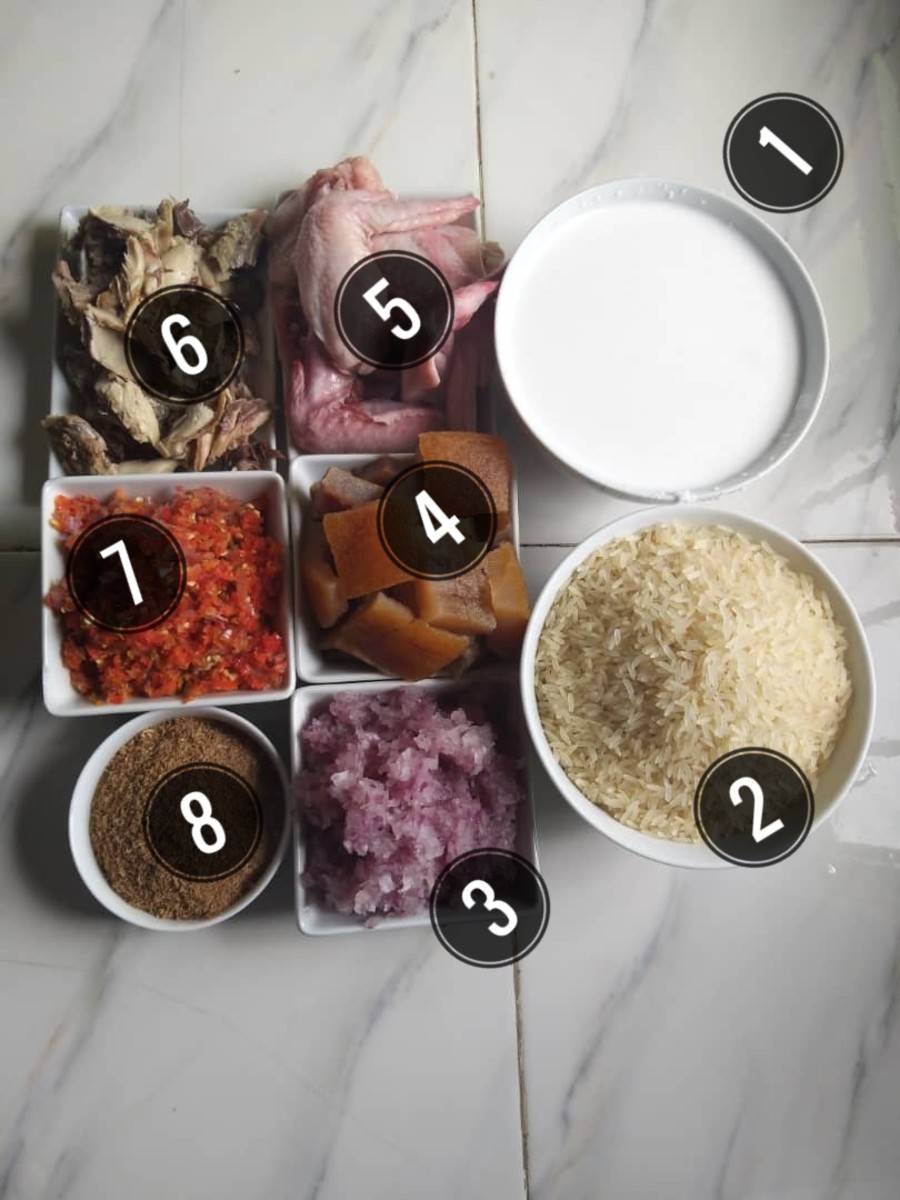 A photo of the ingredients. 1. Coconut milk. 2. Long-grain rice. 3. Shredded onion. 4. Cooked beef skin. 5. Chicken wings. 6. Smoked mackerel. 7. Scotch bonnet. 8. Ground crayfish.
