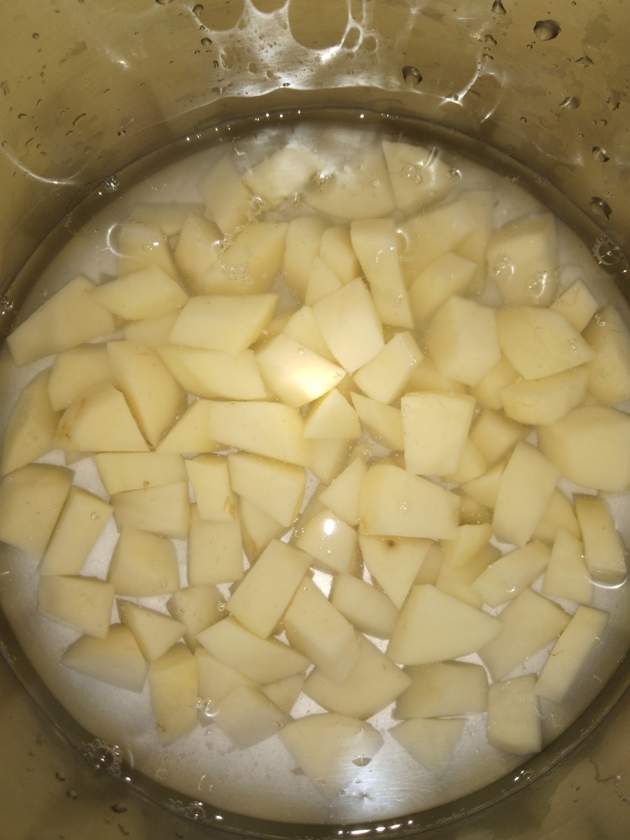 Wash, peel, and cube potatoes into medium-sized pieces. Boil them, adding enough water.