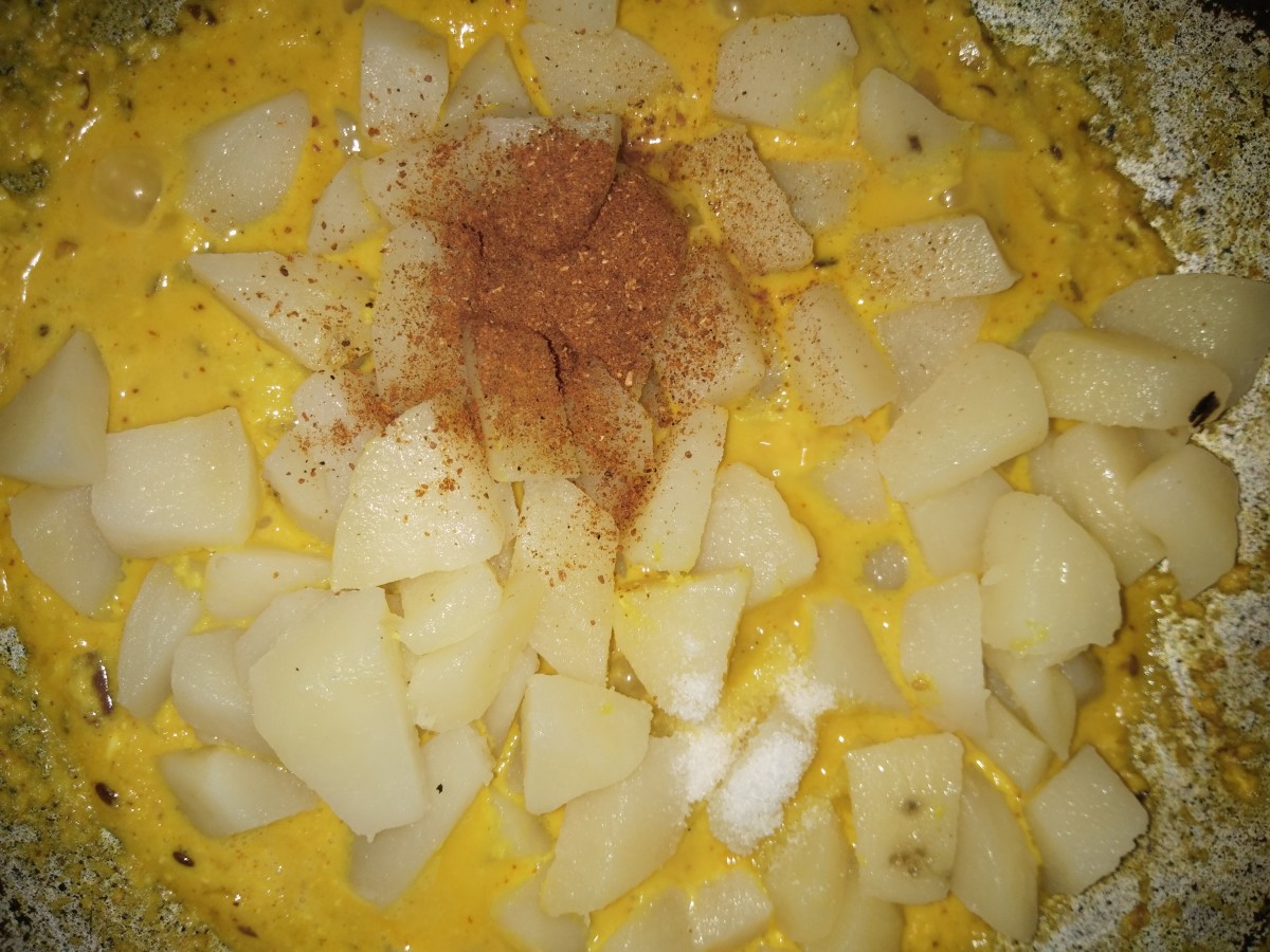 Add beaten curd and cook for 1 to 2 minutes over low flame. Then add boiled potatoes, garam masala powder and salt.
