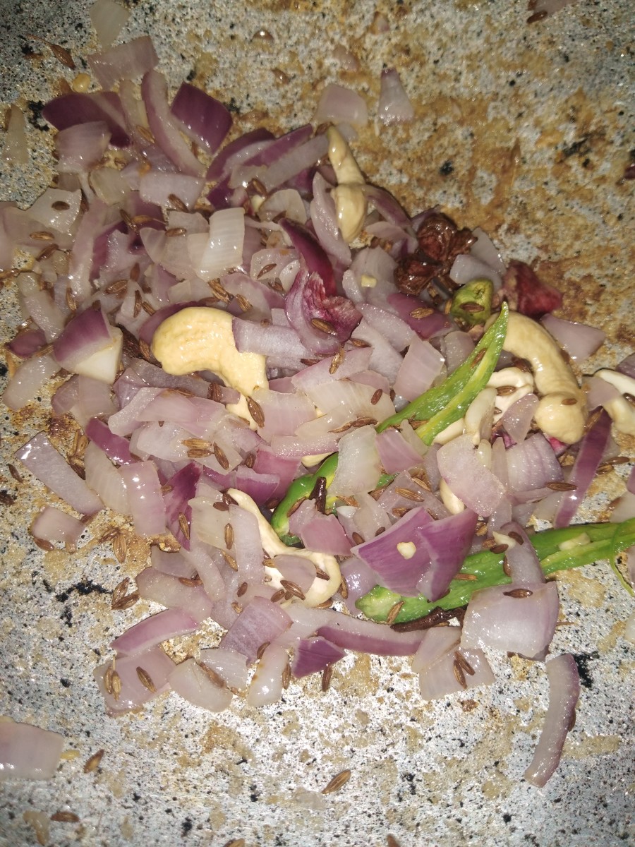 Fry until onion and cashew turn a golden color.