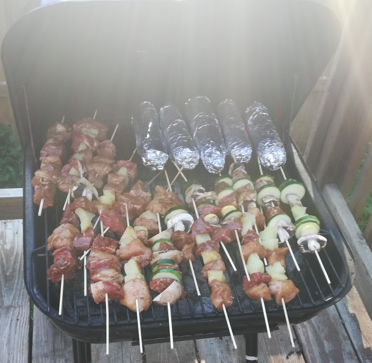 Kabobs on the grill with corn on the cob
