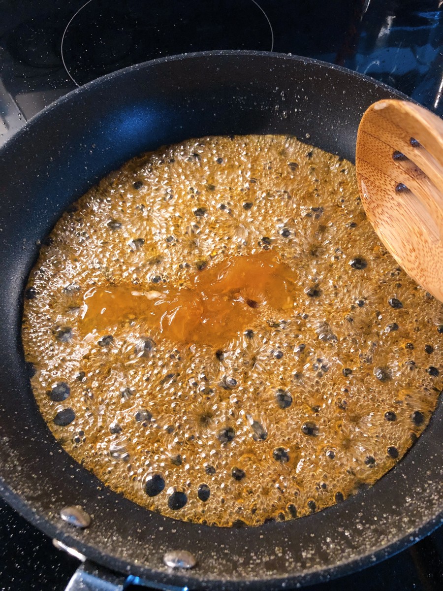Once the sugar is caramelized, add the hot water slowly. 
