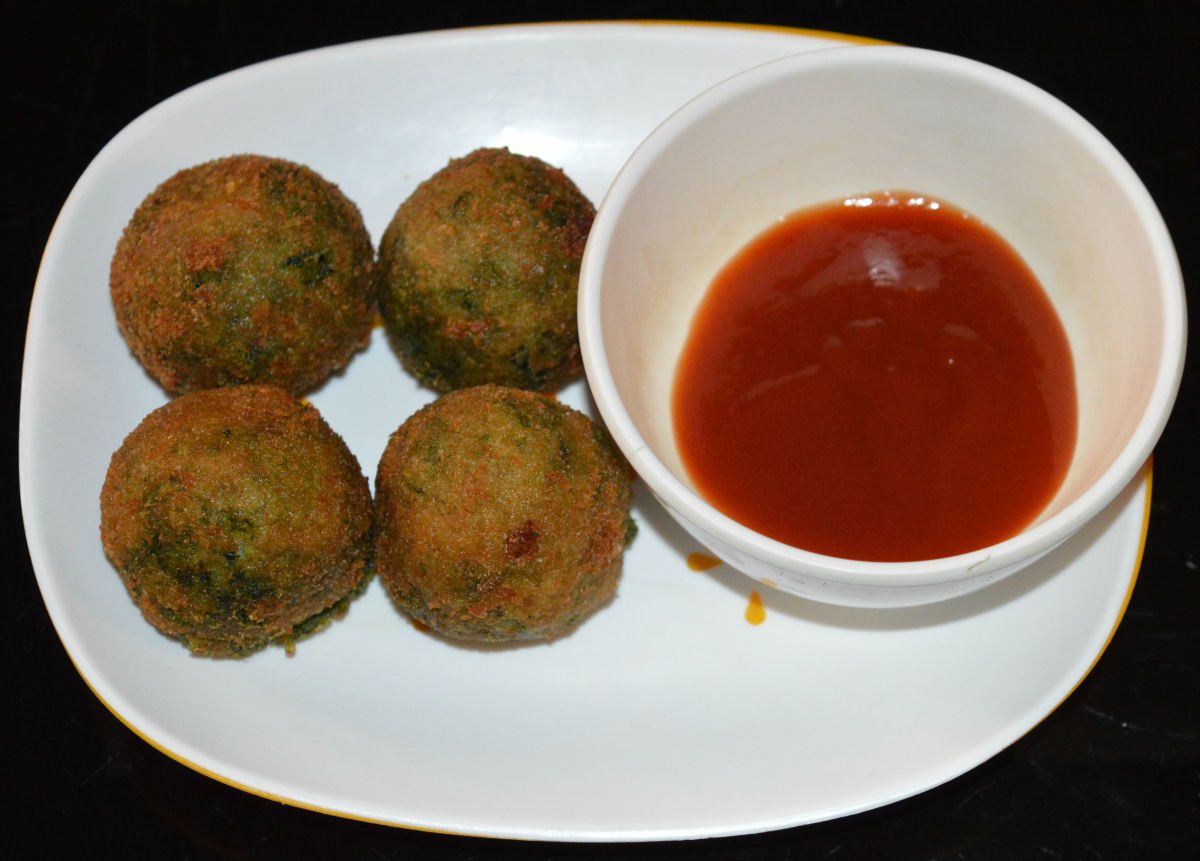 Fry until they become golden brown. Remove them to an absorbent paper. Repeat the same with the remaining balls. Serve hot green kebabs with tomato sauce. Honestly, they are irresistible!