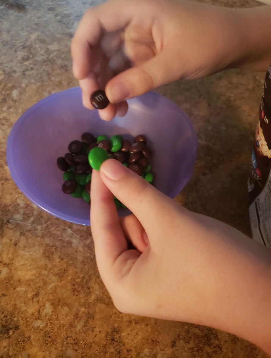 Separate green and brown M&M's into a bowl. 