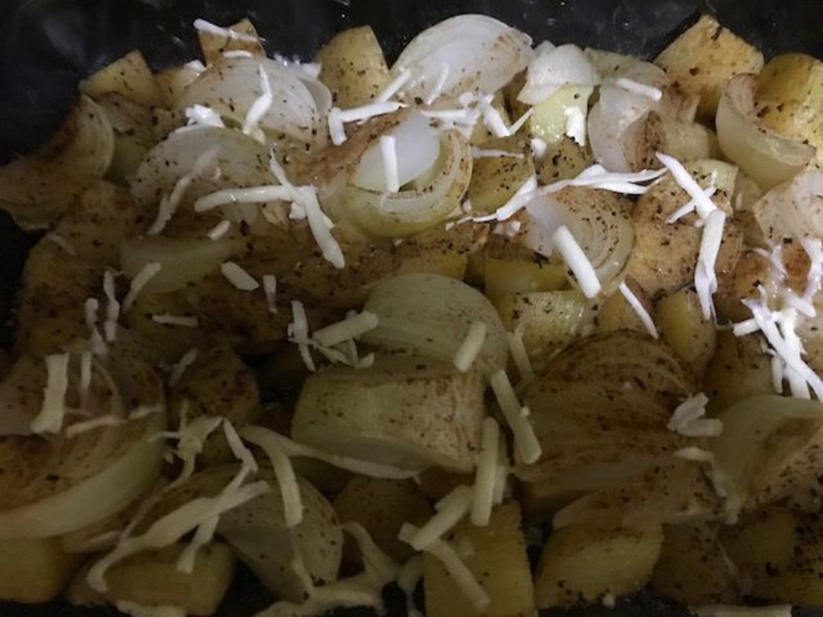 Top the seasoned onions and potatoes with Parmesan cheese.