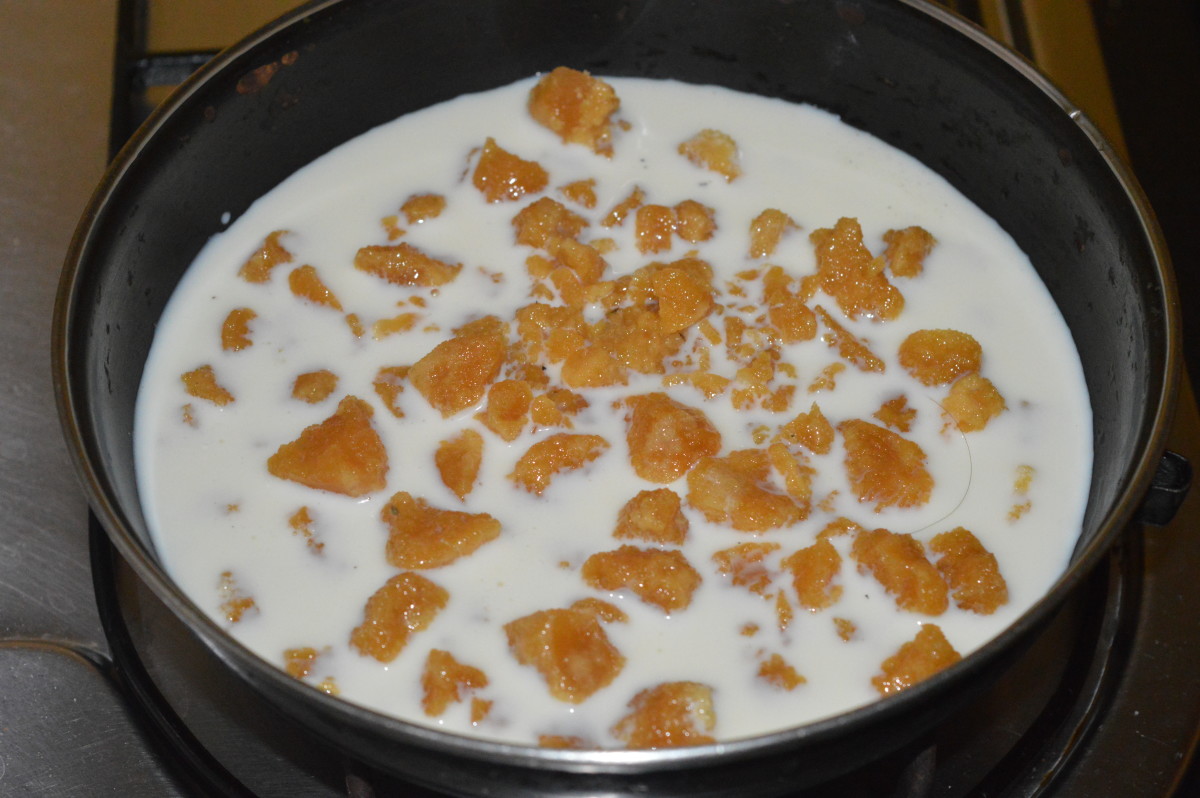Step two: In a deep-bottomed pan, add ginger paste, powdered jaggery, and milk. Heat the pan. 
