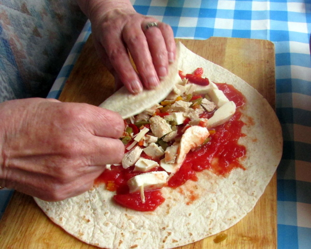 Carefully bring one side of the wrap over the other until you have wrapped the ingredients all together.