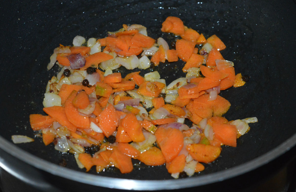 Step two: Add carrot slices and some salt. Saute the mixture for 2 minutes. 
