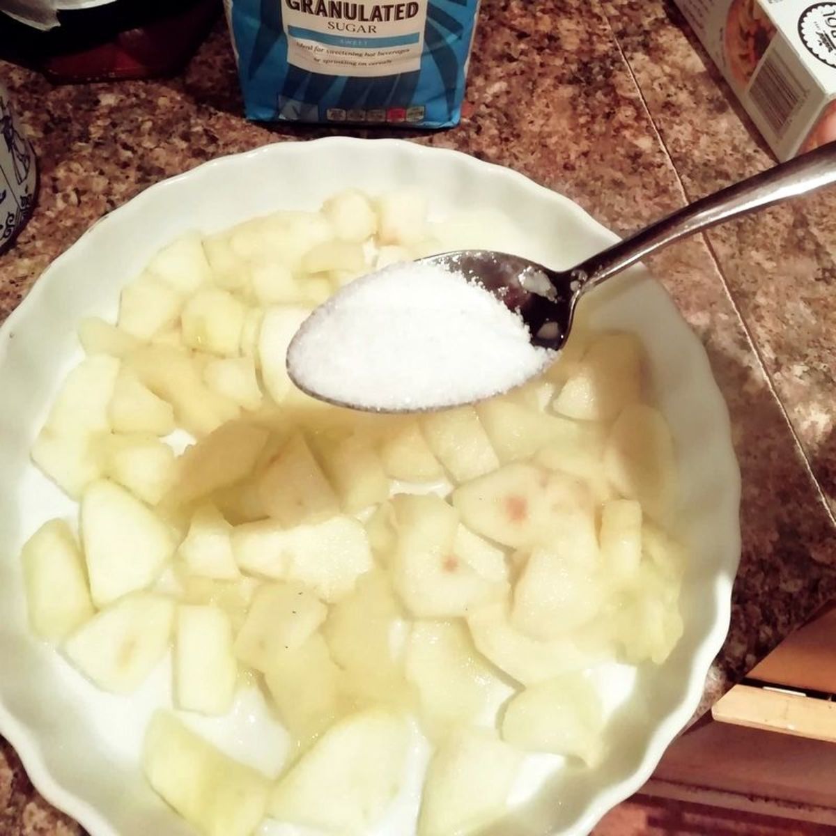 Add the white sugar and mix into the apple pieces.