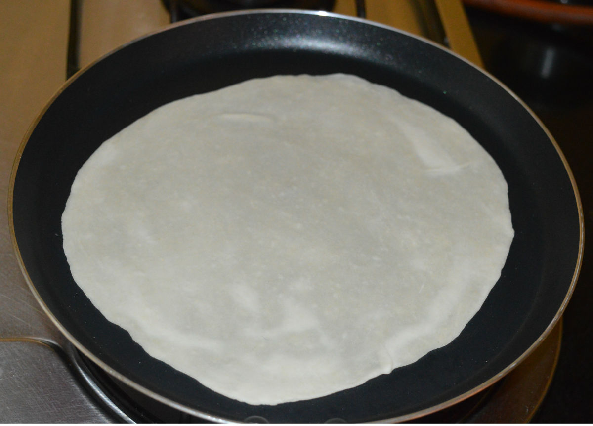 Step four: Make thin tortillas. Make them firm by warming them in a hot pan. Cut out many small tortilla discs from them.
