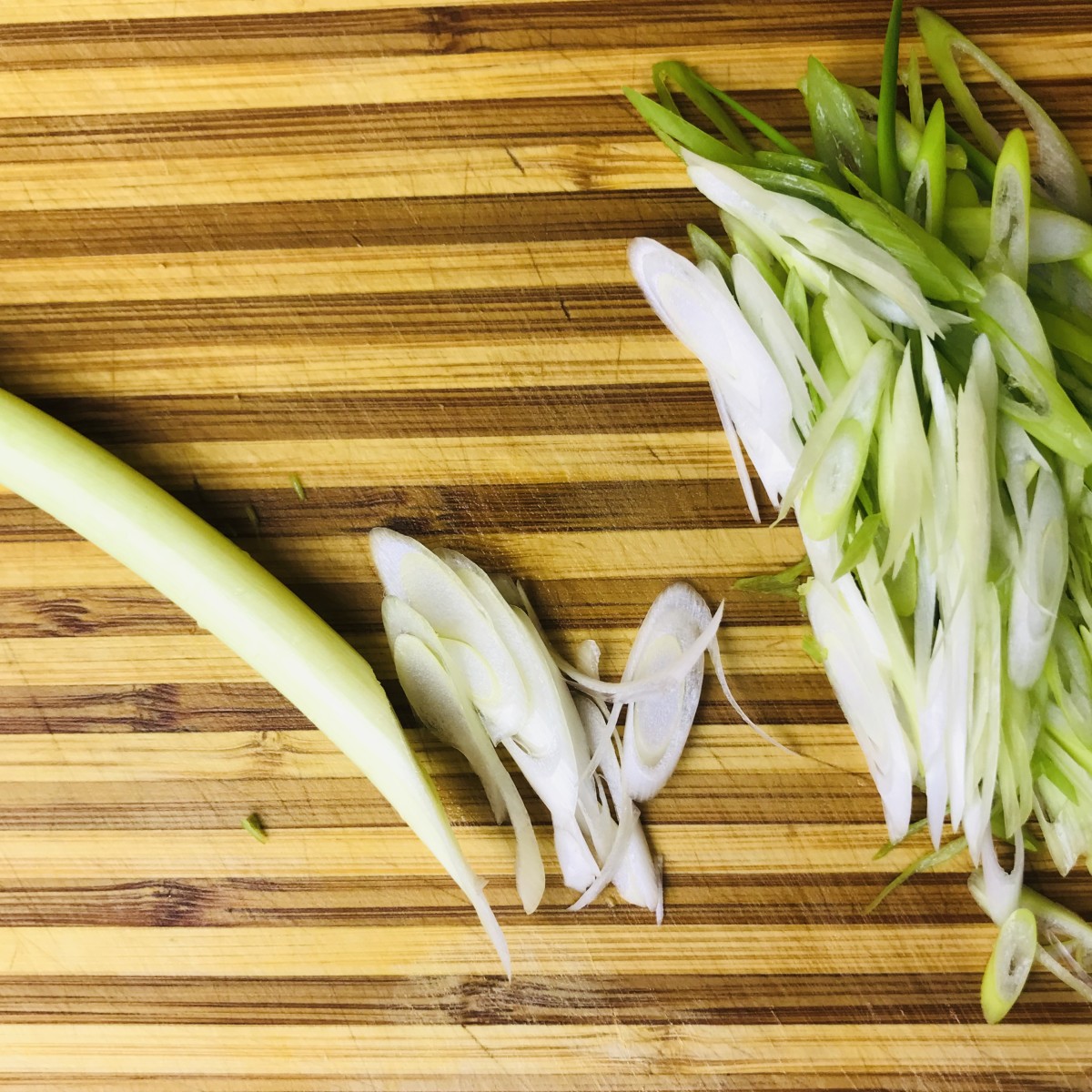 Thinly slice the scallions on the bias. To do this, slice at about a 45 degree angle. For this recipe you will use the entire scallion, both green and white.