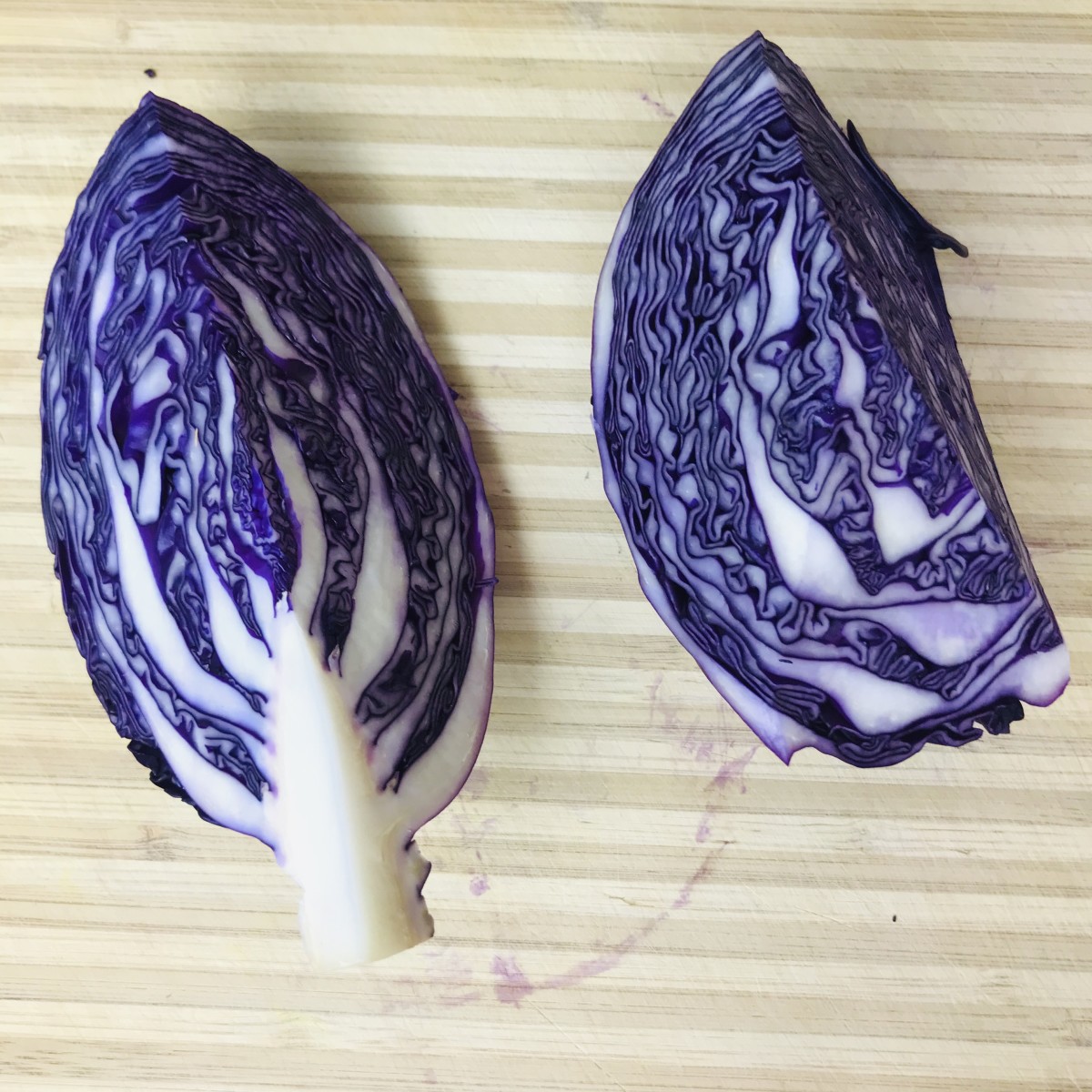 To shred the cabbage, start by quartering it. Take each quarter and remove the core by slicing at 45 degree angle beginning in the middle and moving toward the bottom.