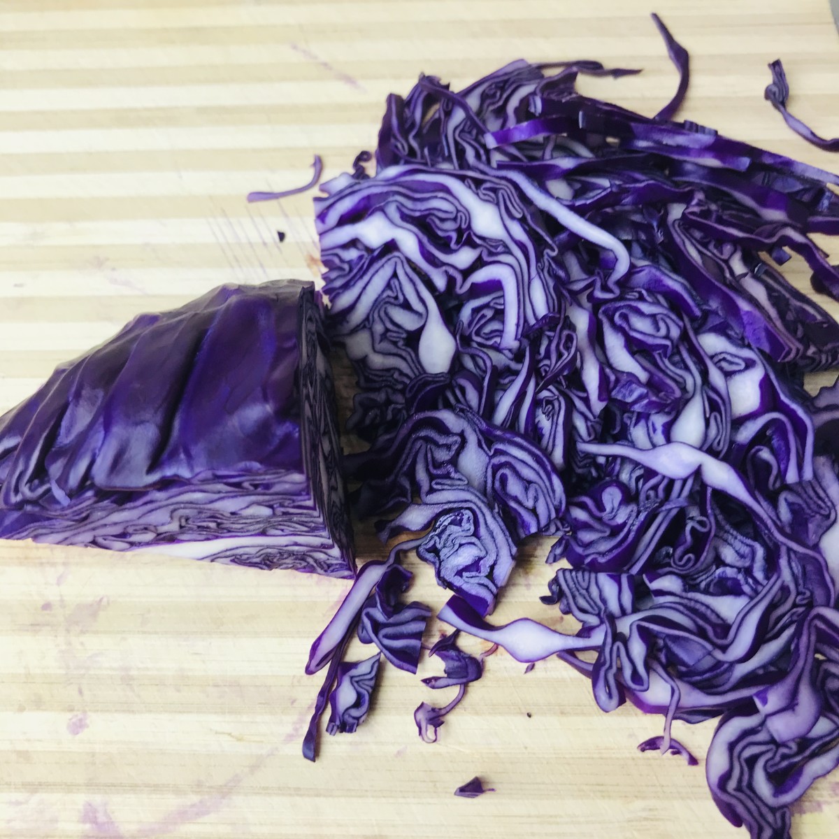 Once the core is removed, thinly slice the cabbage to turn it into shreds.