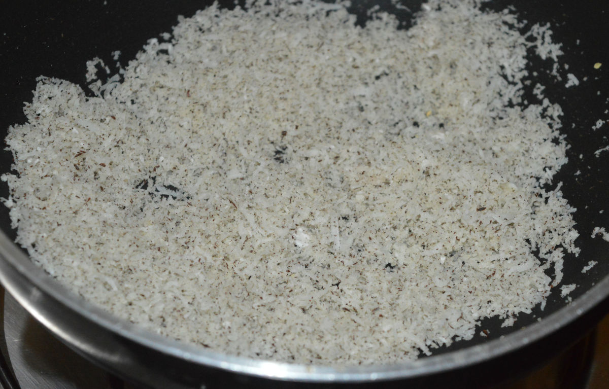 Saute the grated coconut in the same pan until it becomes crispy. Add it to one of the plates.