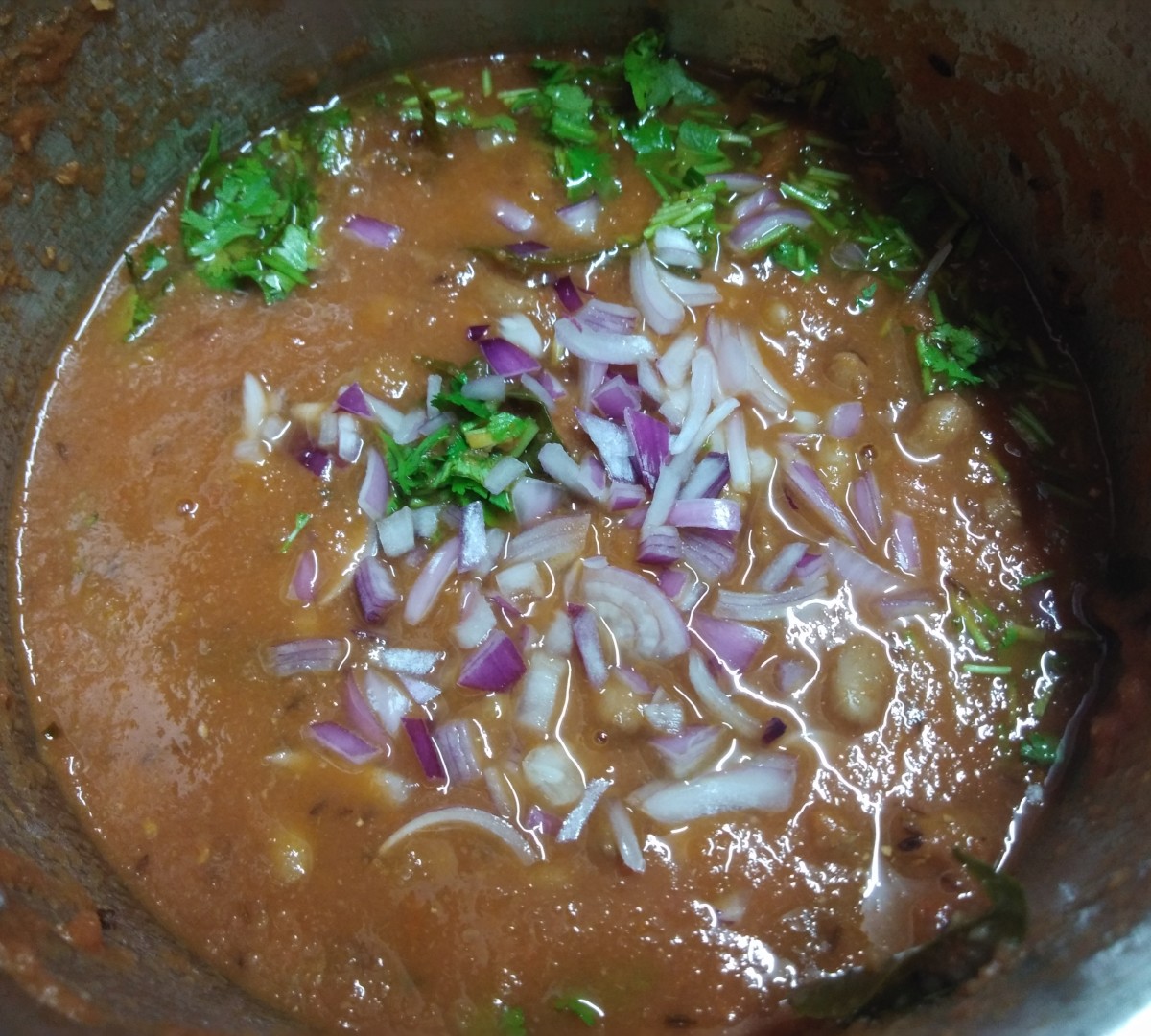 Add finely chopped onion and coriander leaves. 