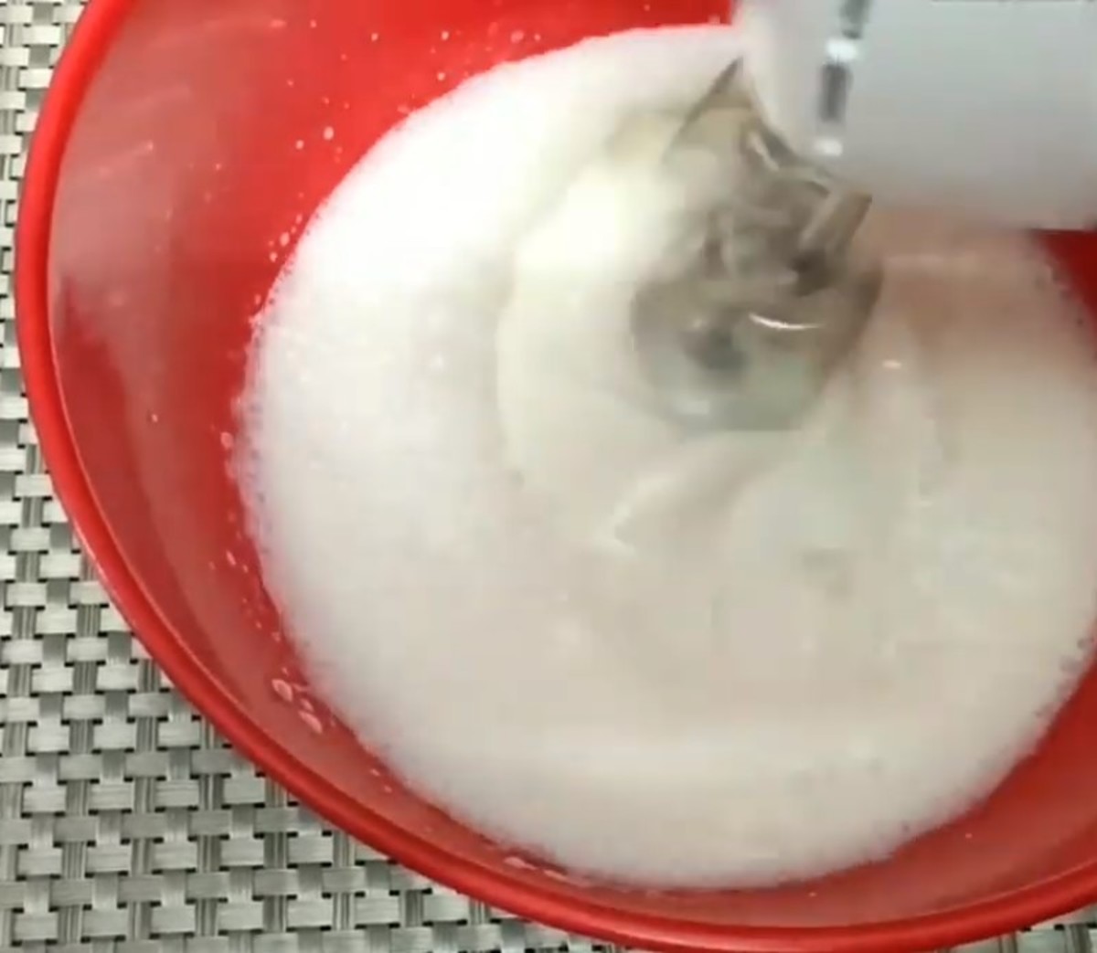 Beating whipping cream with a hand mixer