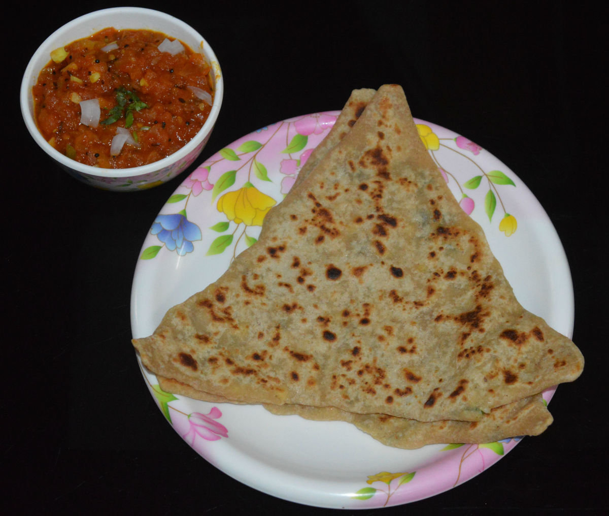 Serve hot paneer parathas with tomato salsa, tomato sauce, or any tangy sauce. Enjoy the taste!