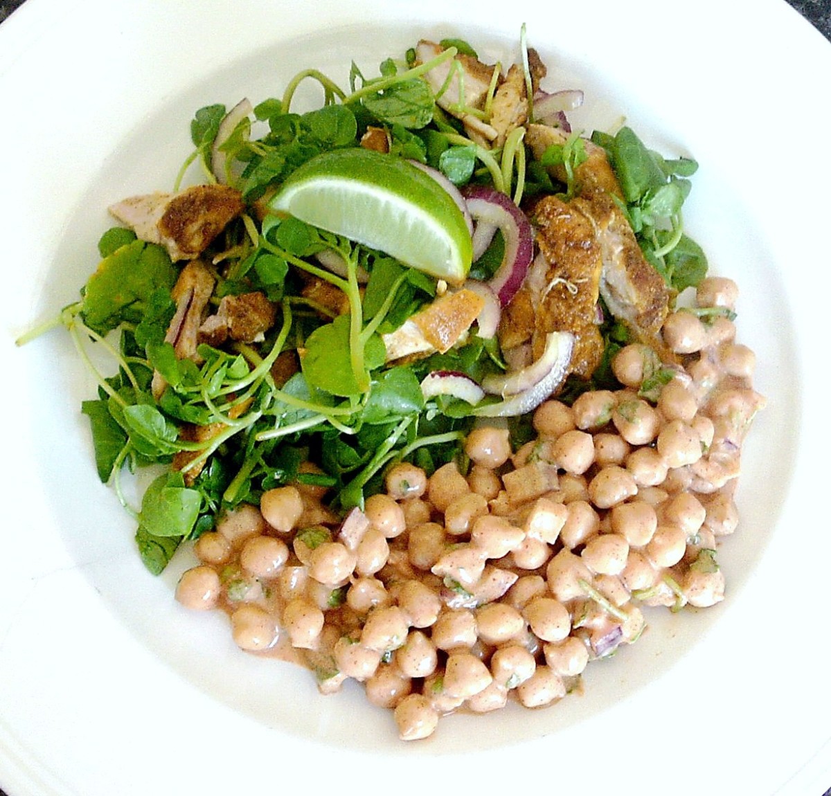 Cold curried chicken thigh salad is served with a spicy chickpea raita