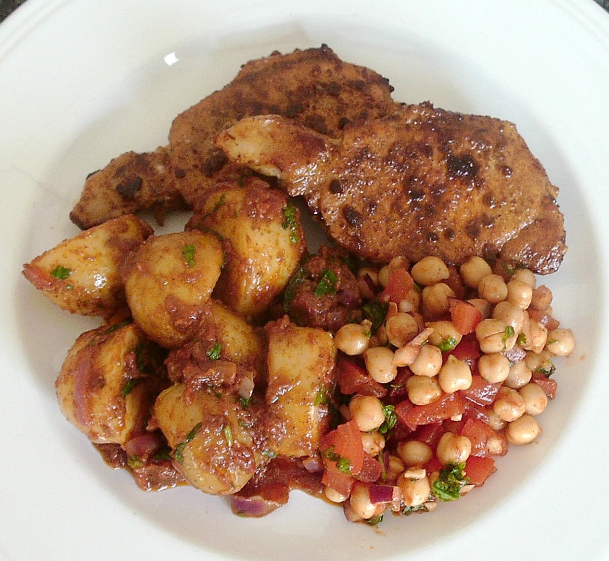 Chilli spiced pork with potato curry and spicy chickpea salad