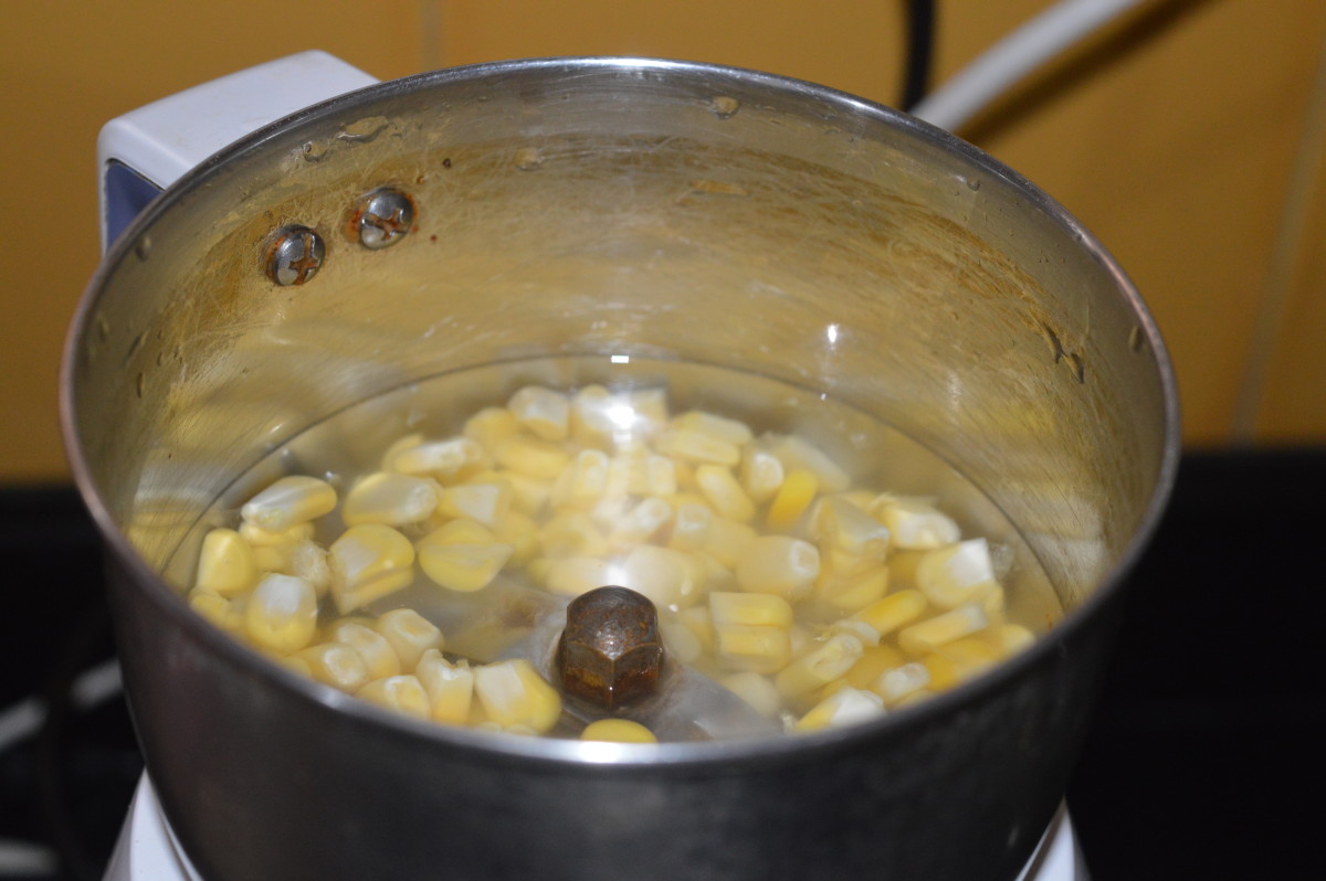 Step one: Add cornflour to a bowl containing a half cup water. Mix well and set aside. In a mixer jar, add a fistful of sweet corn kernels. Add some water. Grind to get a smooth sauce.