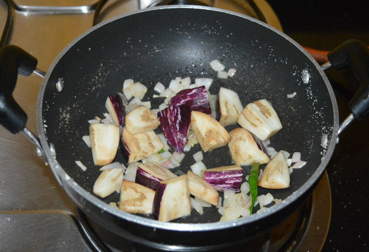Add eggplant cubes and a bit of salt. Increase the heat. Saute for 2 minutes.