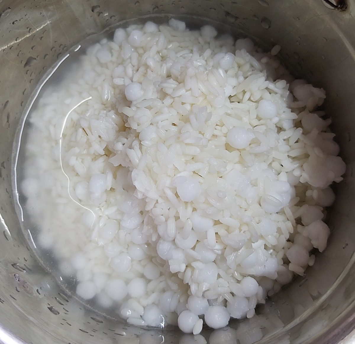 Transfer this mixture to a mixer jar along with enough water to grind (you can use sabudana-rice soaked water only). But don't add too much water as it can make the batter too watery.