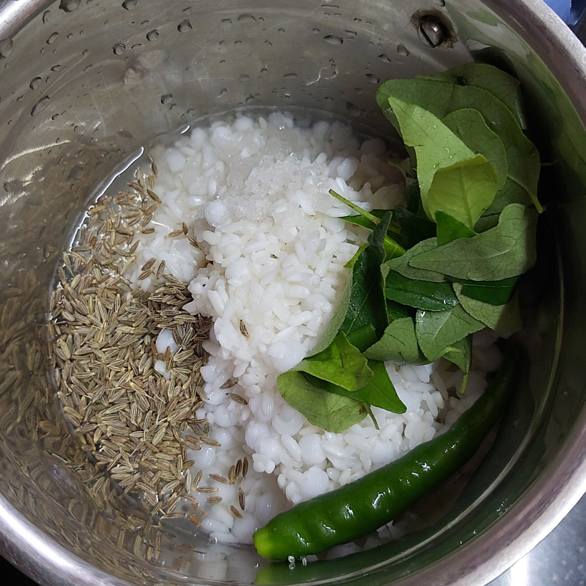 Add 1 teaspoon of cumin seeds, 1-2 strings of fresh curry leaves, 1-2 green chilies and salt to taste.