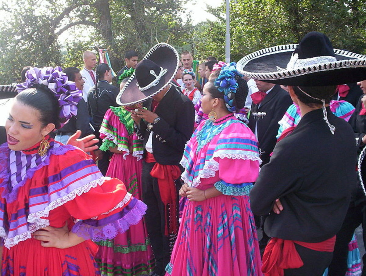 Mexican women and men gather for a festival, wearing traditional dress