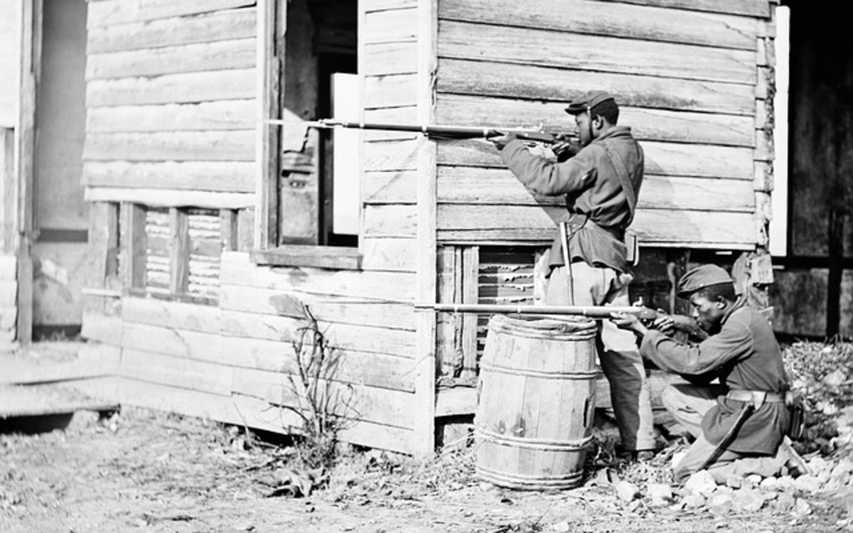 African American soldiers fighting in the American Civil War.  The American Civil War saw the first signs of mechanized warfare, which would become more apparent with the onset of World War I later in Europe.