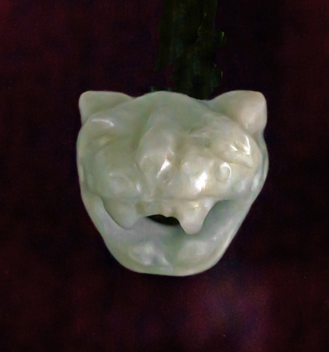 Small jadeite amulet with jaguar motif.