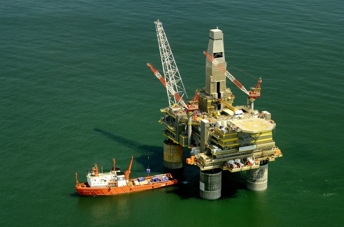 Oil is extracted from under the ground using huge structures called oil rigs. They drill down thousands of feet into the ground or sea bed and the oil rises to the surface through hollow steel pipes.