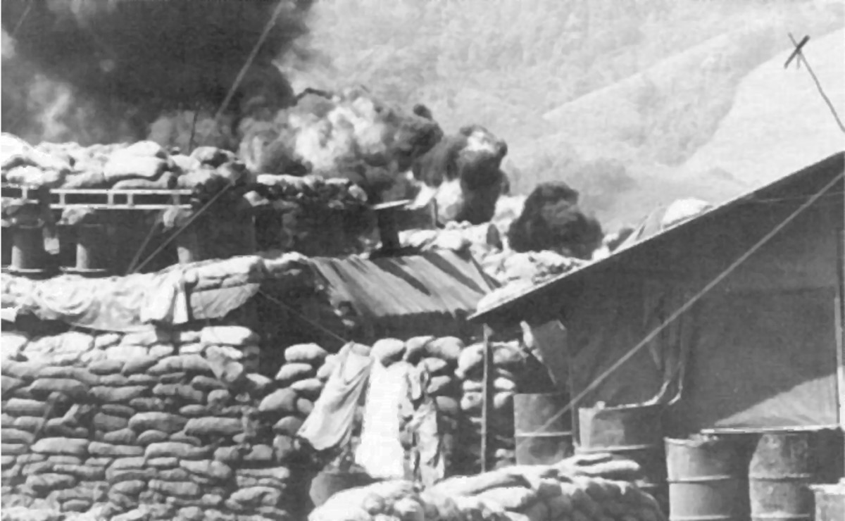 Khe Sanh Bunkers and burning Fuel Dump from a direct hit by enemy fire near the airstrip.