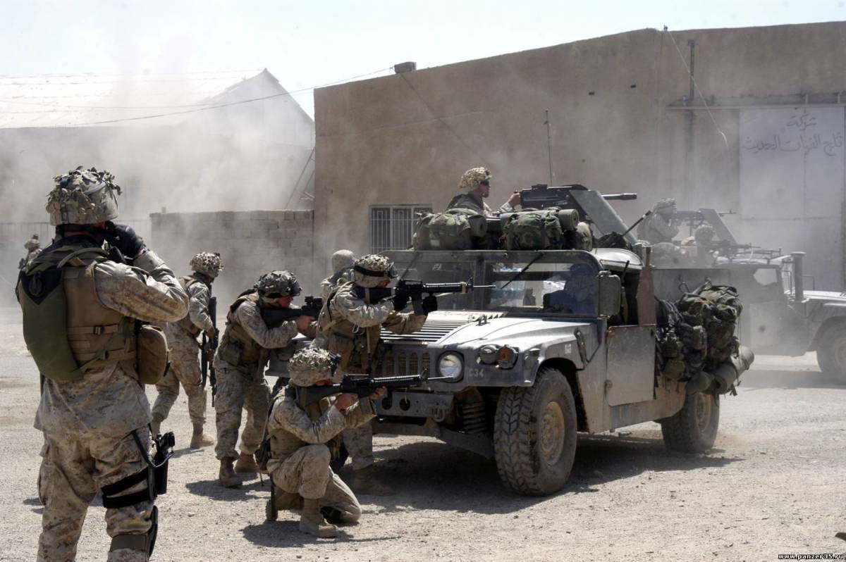 U.S. Marines from 1st Battalion, 5th Marines fire at insurgent positions during the First Battle of Fallujah.