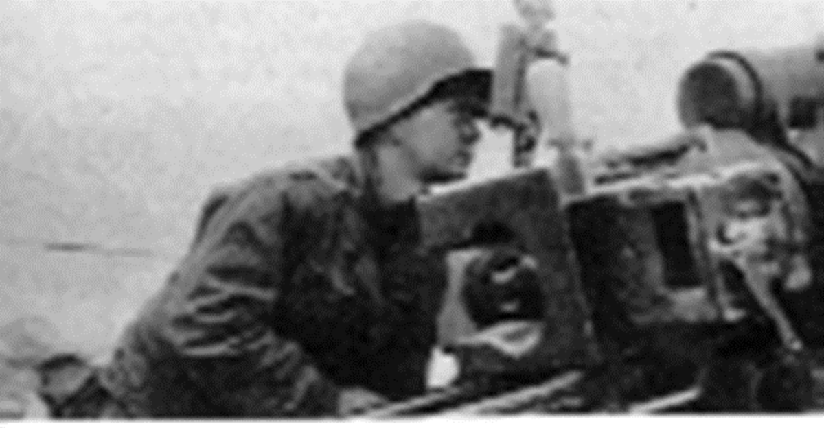Gunner Corporal using the M12 Panoramic Scope.