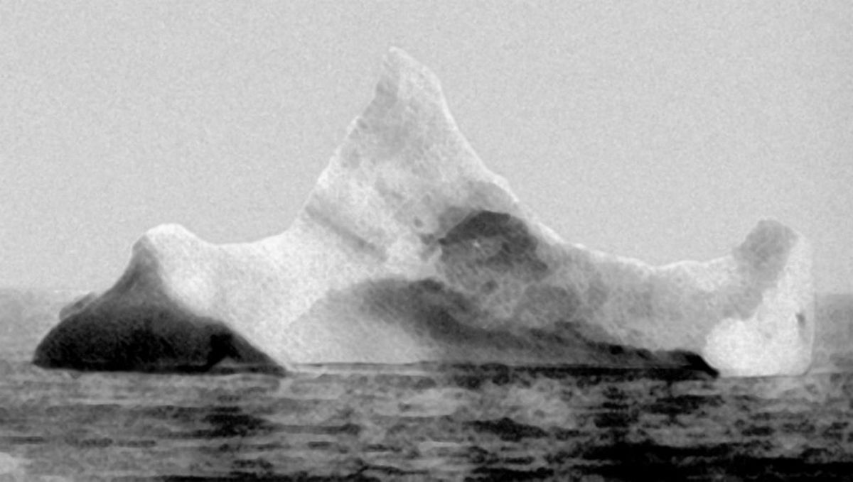 A photograph from the morning of 15 April 1912, showing the iceberg that it is thought that Titanic hit. The hull was not punctured by the iceberg, but dented badly enough to damage the seams and let water seep in. The ship then went down bow first.