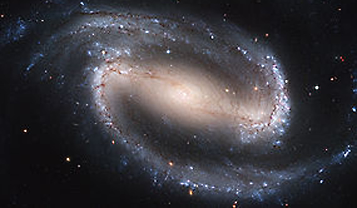 'NGC1300' - a typical galaxy similar to our own. One must be clear that in binoculars or even small telescopes, nothing like this clarity is possible. The  quality of lens resolution is not sufficient to show anything more than a faint smudge