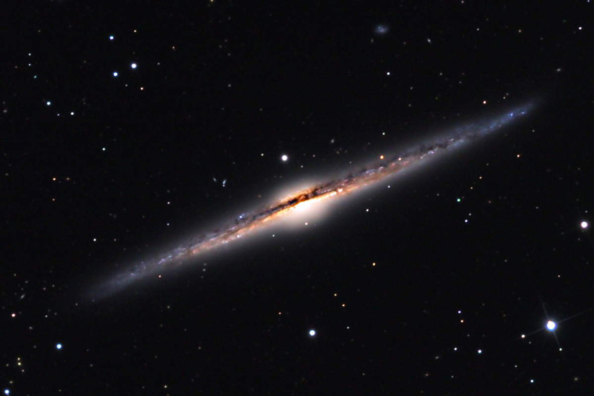 This is the galaxy NGC 4565, shown here because it is believed our galaxy would look very like this when viewed from the side. (Note the dark central band - relevant to the Milky Way image and video shown below)