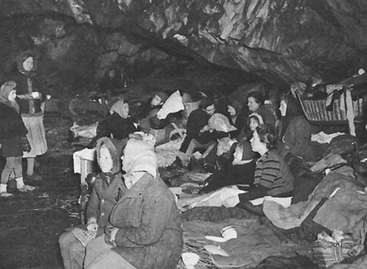 Civilians from the village of Schonberg huddle in a cave near the frontline. 