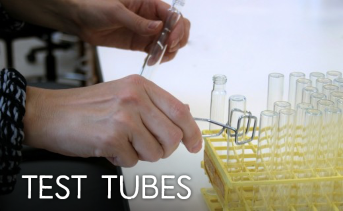 Test tubes being lifted with tongs from a rack