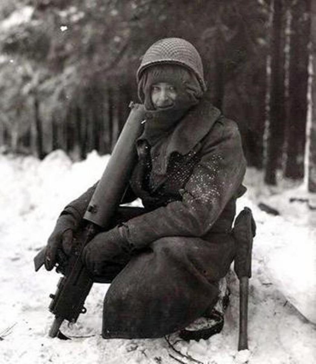 Soldier with water-cooled .30 caliber machine gun during the Bulge. 