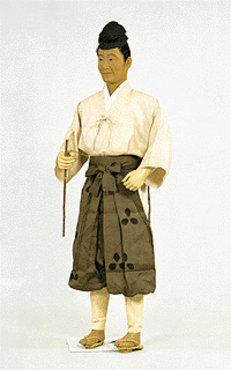 The dress of a Heian Period commoner. His practical workman's 'hitatare' will become the standard of dress when the samurai come to power.