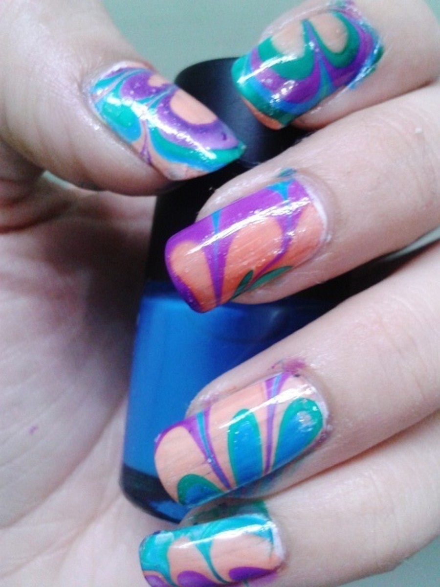Water marble nail art using four bright color nail polishes