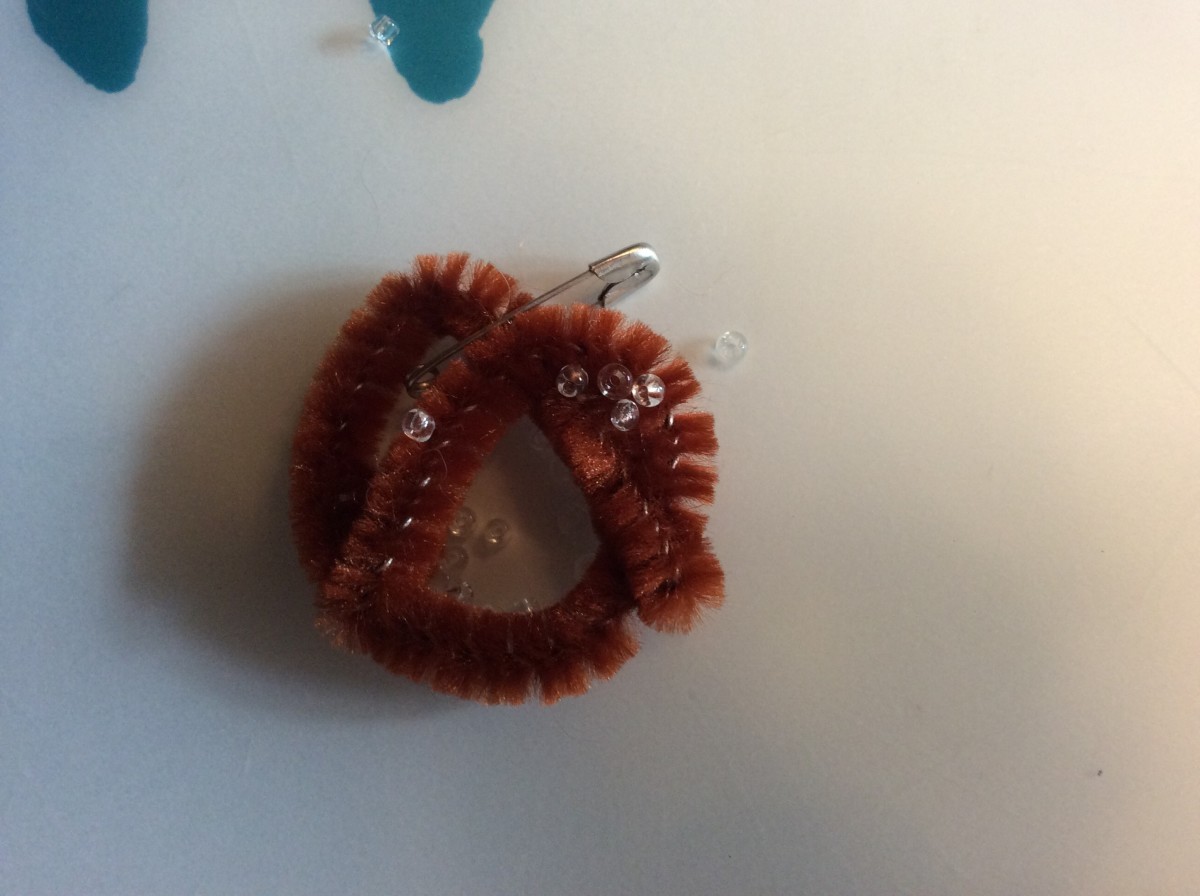 Pretzel swap made from brown pipe cleaner and glued on tiny beads.