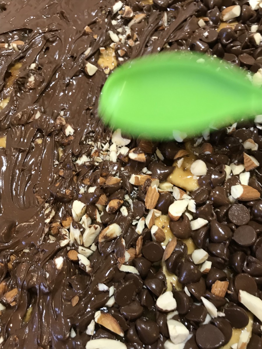 Spread Out the Chocolate: With the back of a silicone spoon or spatula, gently spread out the softened chocolate, pressing the almonds into the chocolate as you go. 